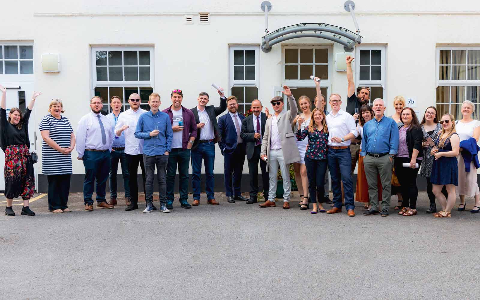 Wide photo of the BFBS academy graduation team celebrating.