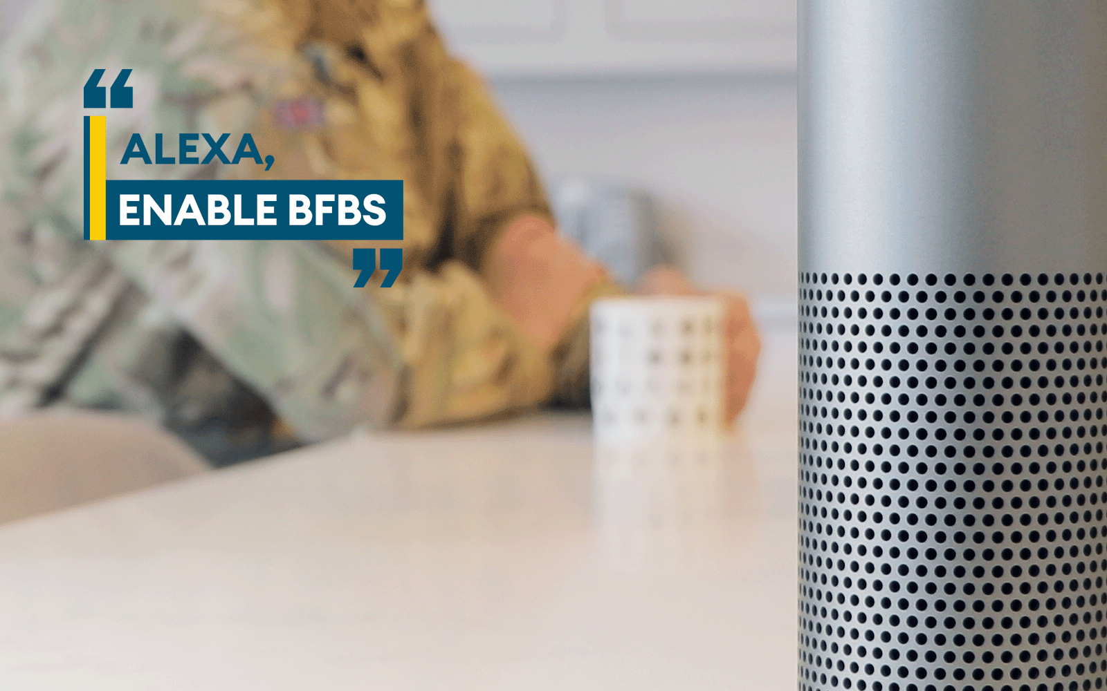 Close up of a smart speaker, serving soldier in background with a mug. Text 'Alexa, Enable BFBS'.