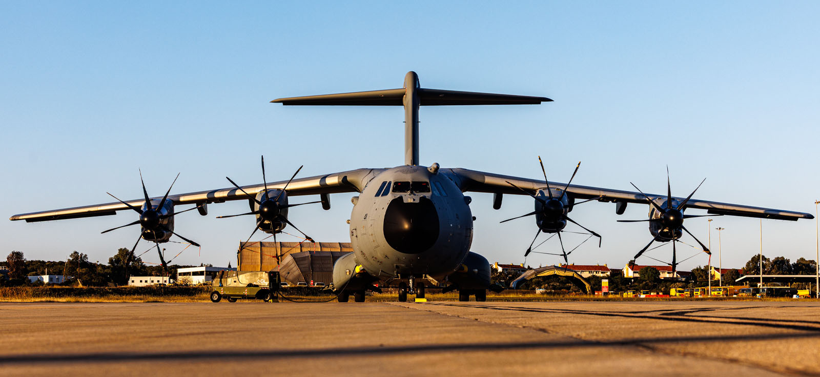 Wide photo of an RAF plane on a runway.