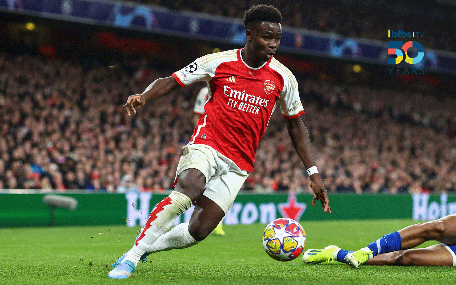 Action shot of an Arsenal football, dribbling with a football.