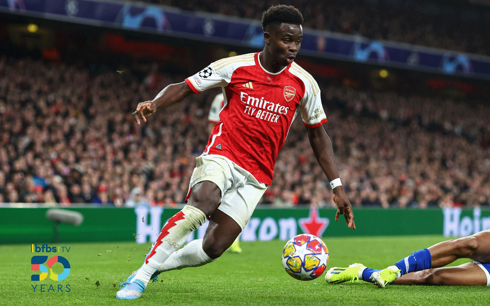 Action shot of an Arsenal football, dribbling with a football.