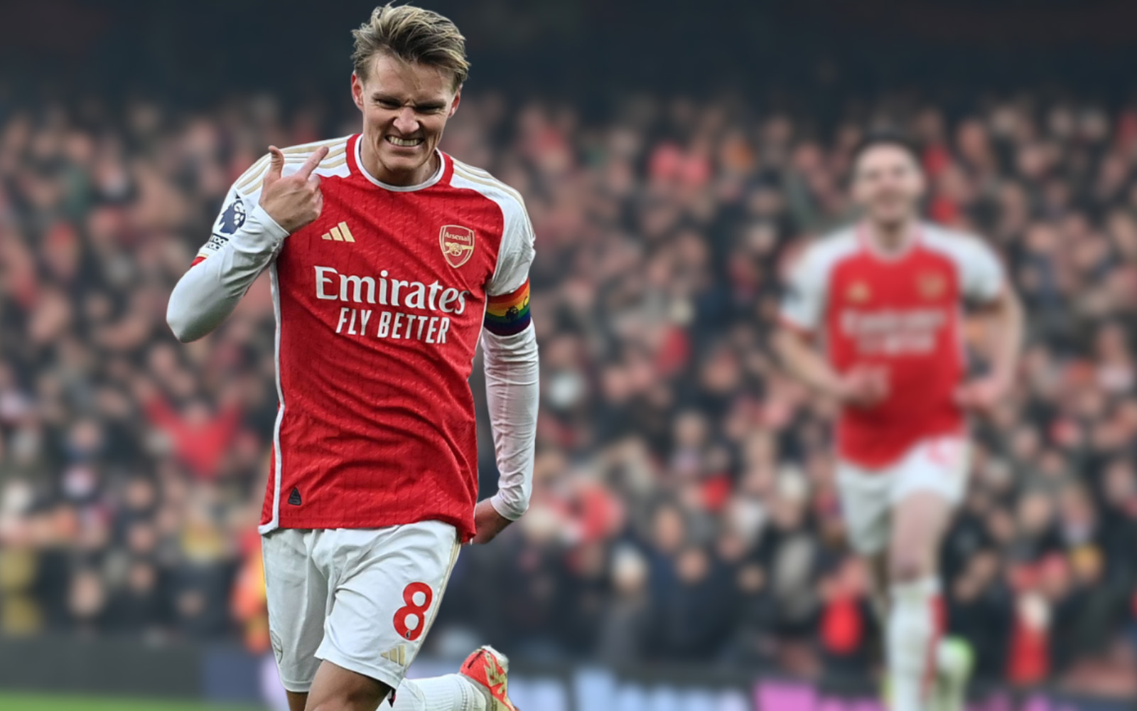 Close up photo of Arsenal football player Martin Ødegaard, with crowd in background.