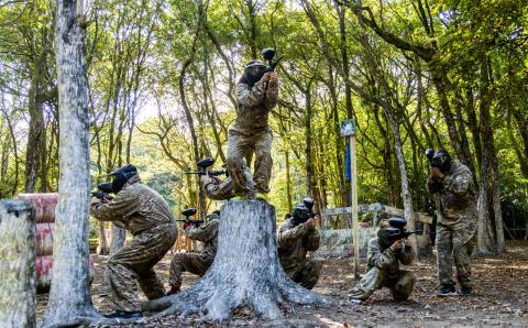 Hand full of paintball participants in action.