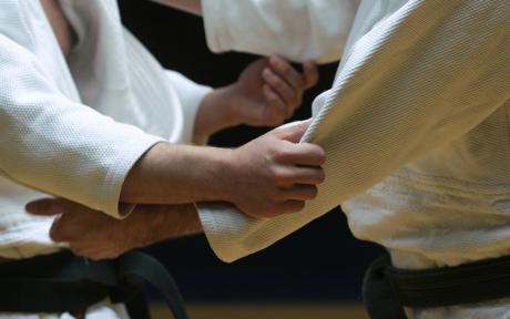 Close up of two competitors grappling.