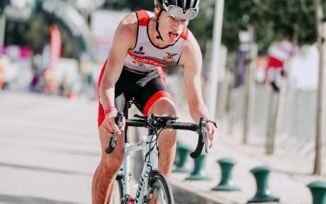 Close up of competitor riding a bike.