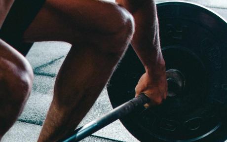 Close up of someone lifting weights.