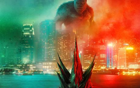 Godzilla swimming towards King Kong.