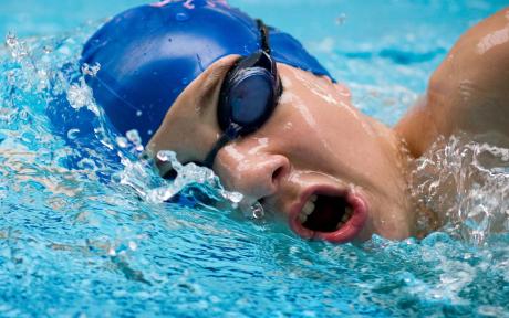 Close up of swimmer in pool swimming.