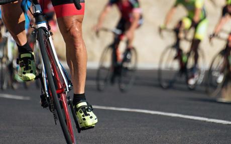 Close up of road race cyclist with others behind.