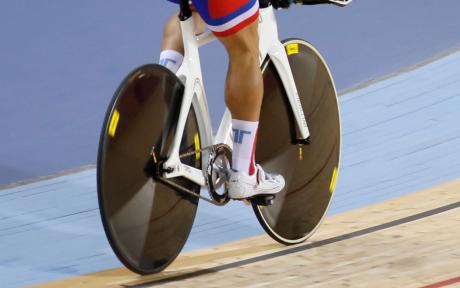 Close up of cyclist on a velodrome track.
