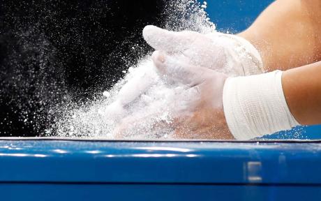 Close up of someone mixing dry powder on their hands