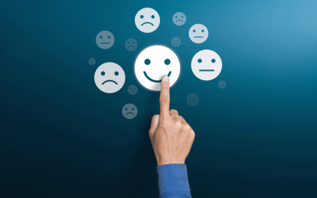 Finger pointing towards a series of emojis.