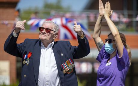 Veteran and care worker looking to to the sky and celebrating.
