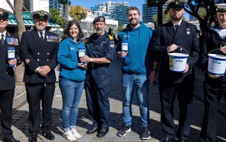 Team BFBS and armed forces volunteers on the streets of Gibraltar posing with BFBS Bug Salute collection buckets.