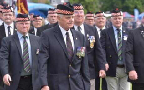 Group of veterans walking together at a memorial event.
