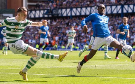Close up action shot involving players from Celtic and Rangers, in an Old Firm Derby.