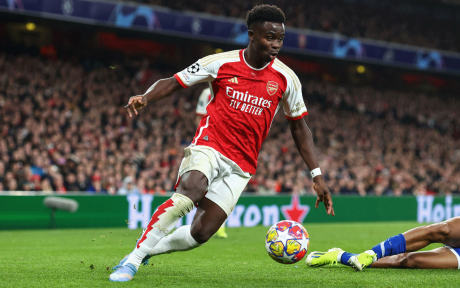 Action shot of an Arsenal football, dribbling with a football.