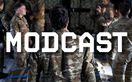 Group of military individuals in a room, text 'MODCAST'.