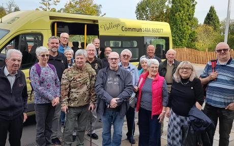 Photo of a group of veterans in front of a bus.