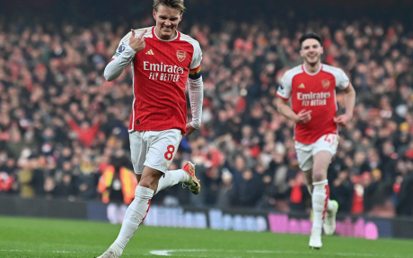 Action shot of Arsenal footballer Martin Ødegaard celebrating a goal.
